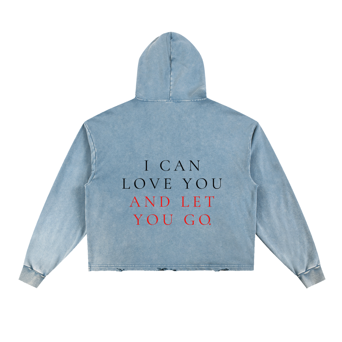 A light blue acid-wash cropped hoodie shown from the back, featuring the text 'I CAN LOVE YOU AND LET YOU GO' printed on the back in black and red lettering.