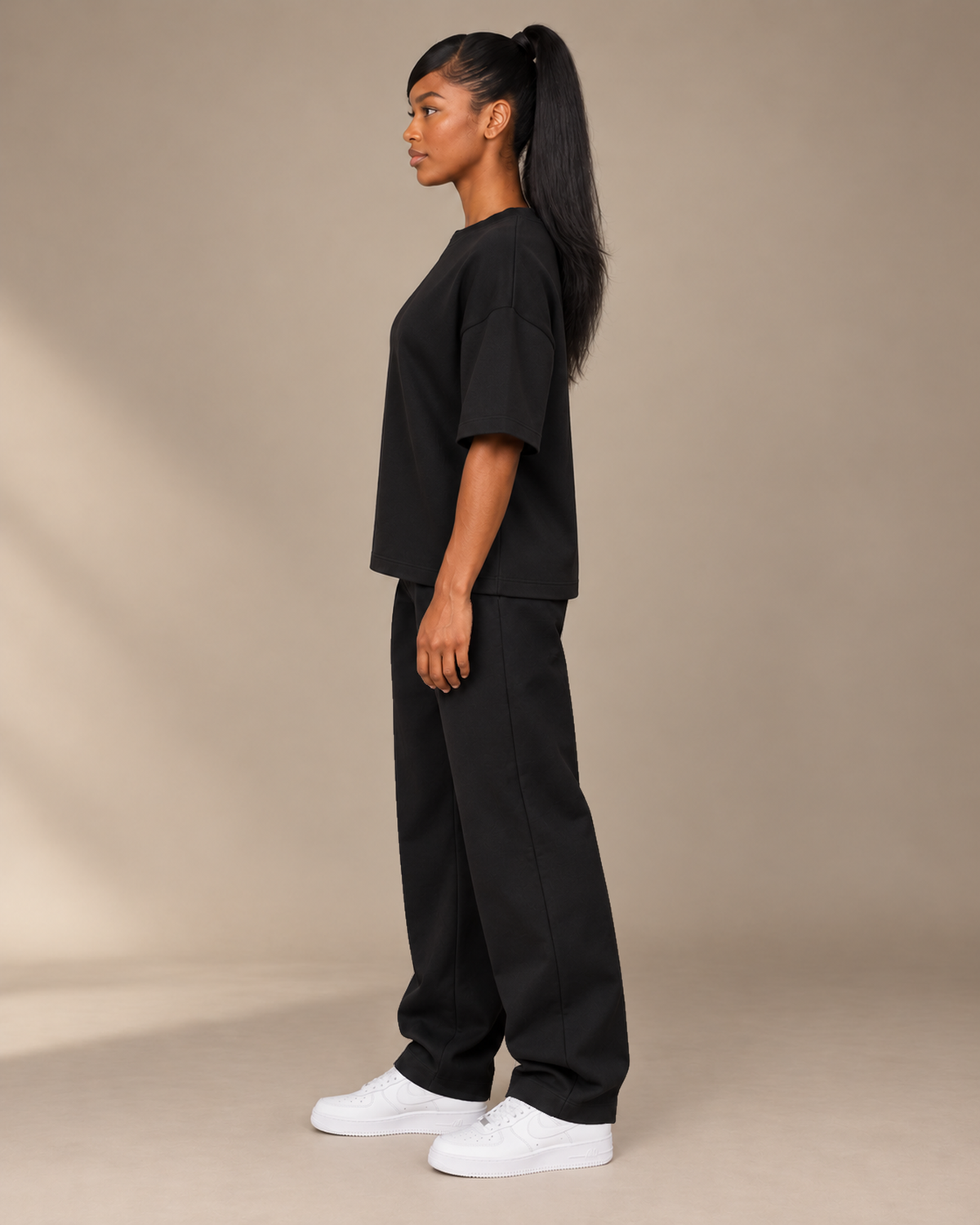 TLOL Lightwell oversized tee in Black, left-facing side view on a model.