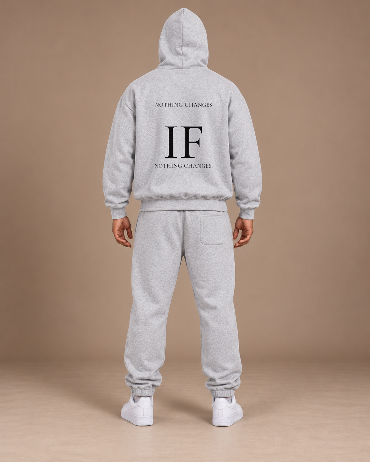 Male model wearing the Flower Gray TLOL Threshold set, back view with NOTHING CHANGES / IF / NOTHING CHANGES on the hoodie
