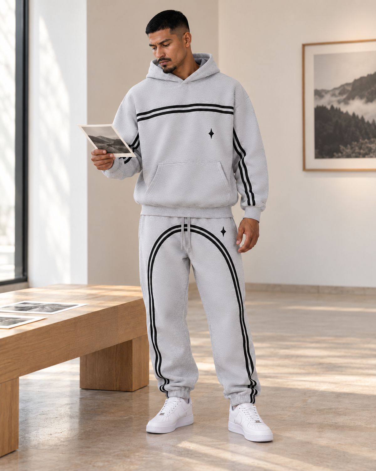Male model wearing the Flower Gray TLOL Threshold hoodie and matching joggers, lifestyle view