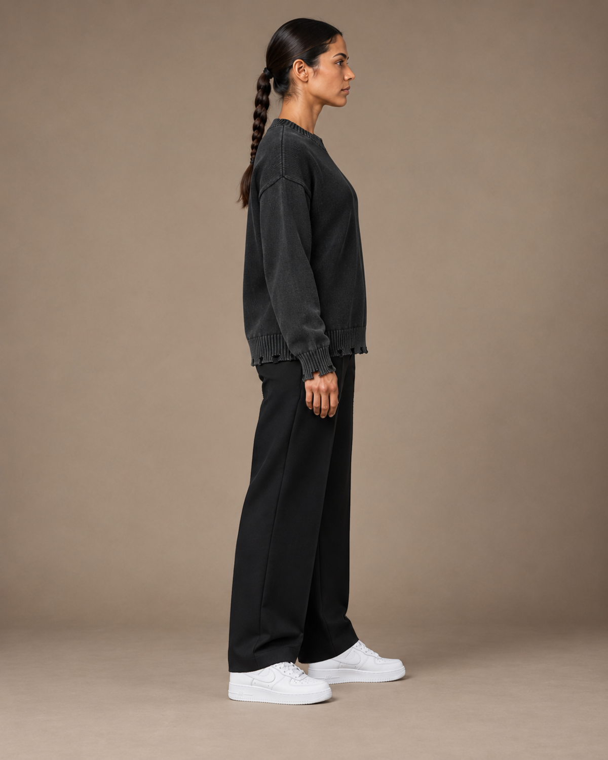 Female model wearing TLOL Black frayed sweater, right view