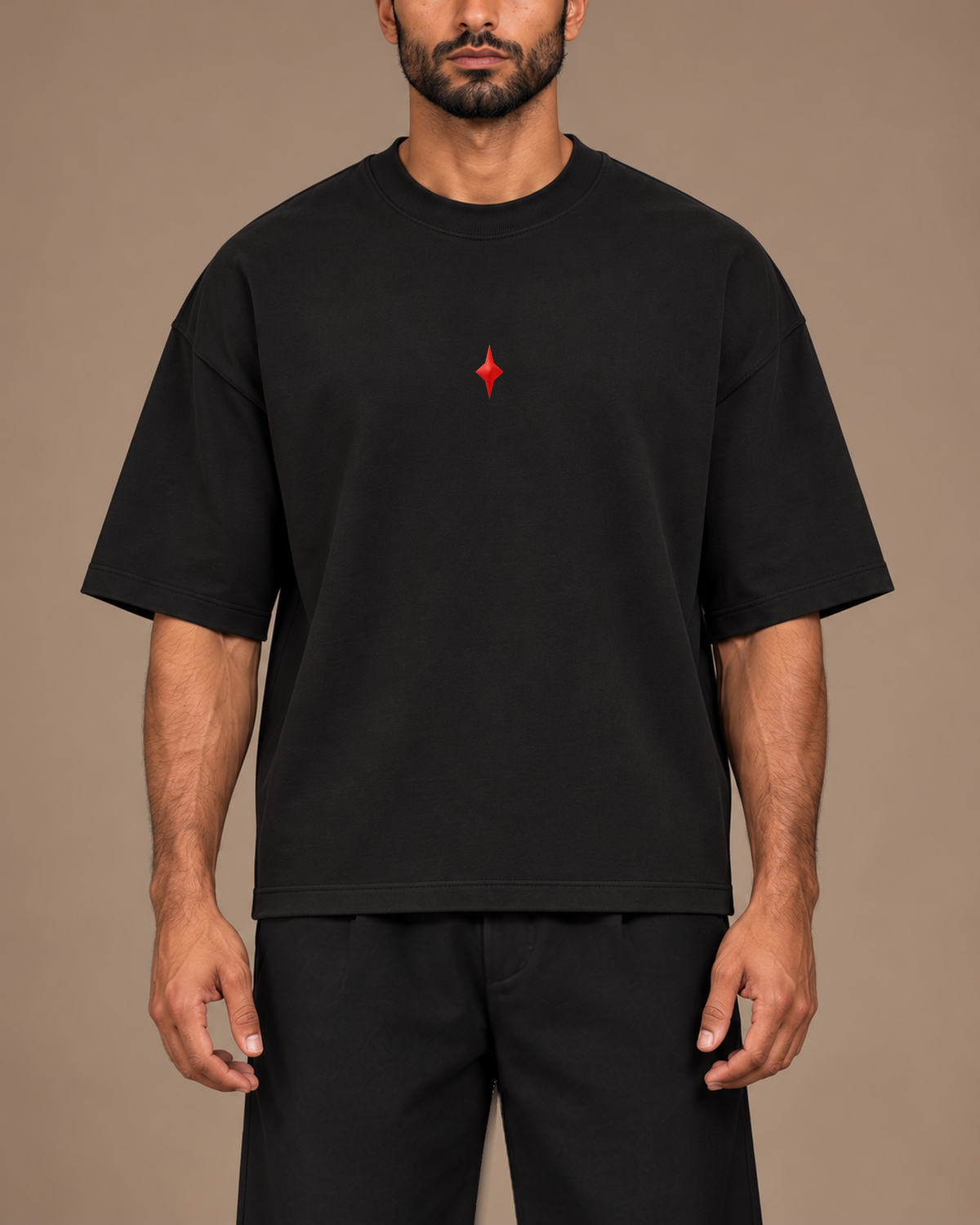 TLOL Lightwell oversized tee in Black, close-up of the red chest emblem and relaxed fit.