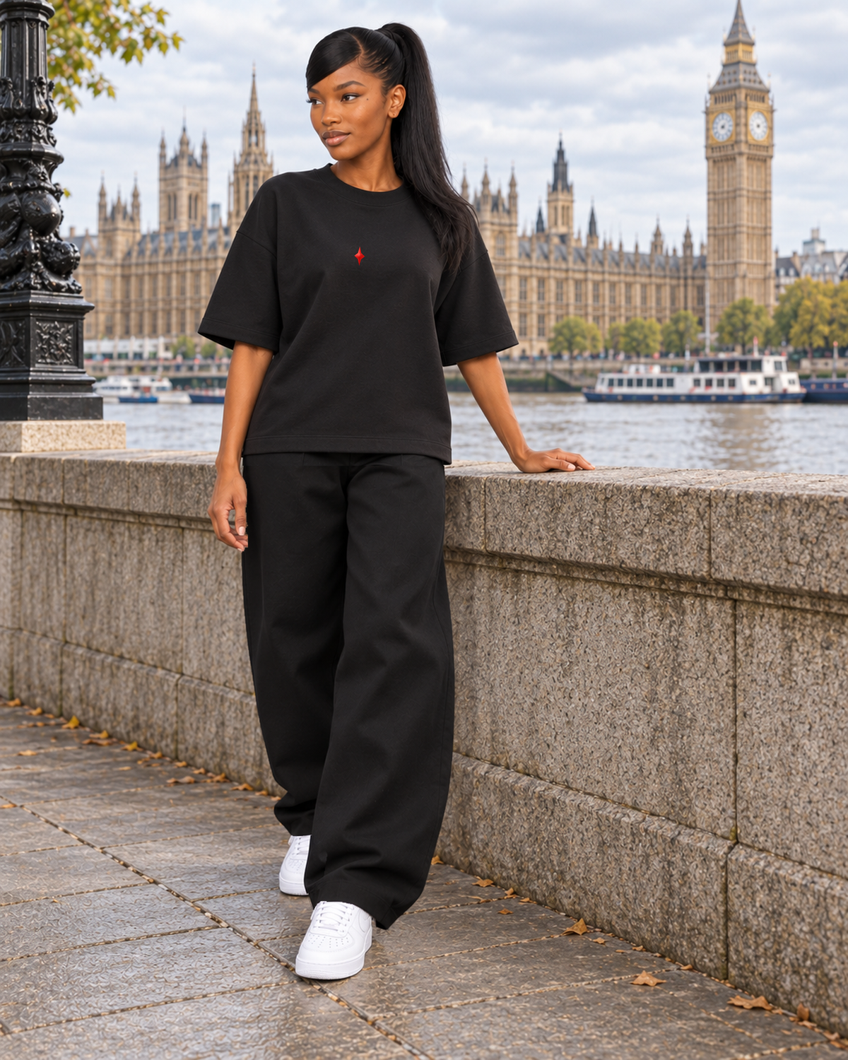 TLOL Lightwell oversized tee in Black, model styled with black trousers in a Westminster-inspired scene.
