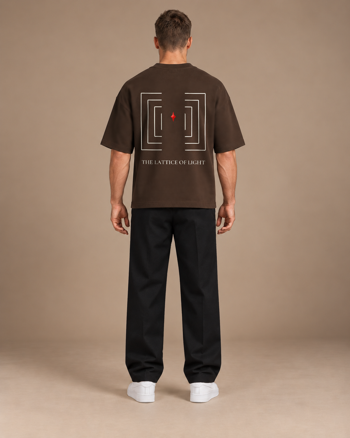 TLOL Lightwell oversized tee in Coffee, back view on a model showing the geometric artwork.