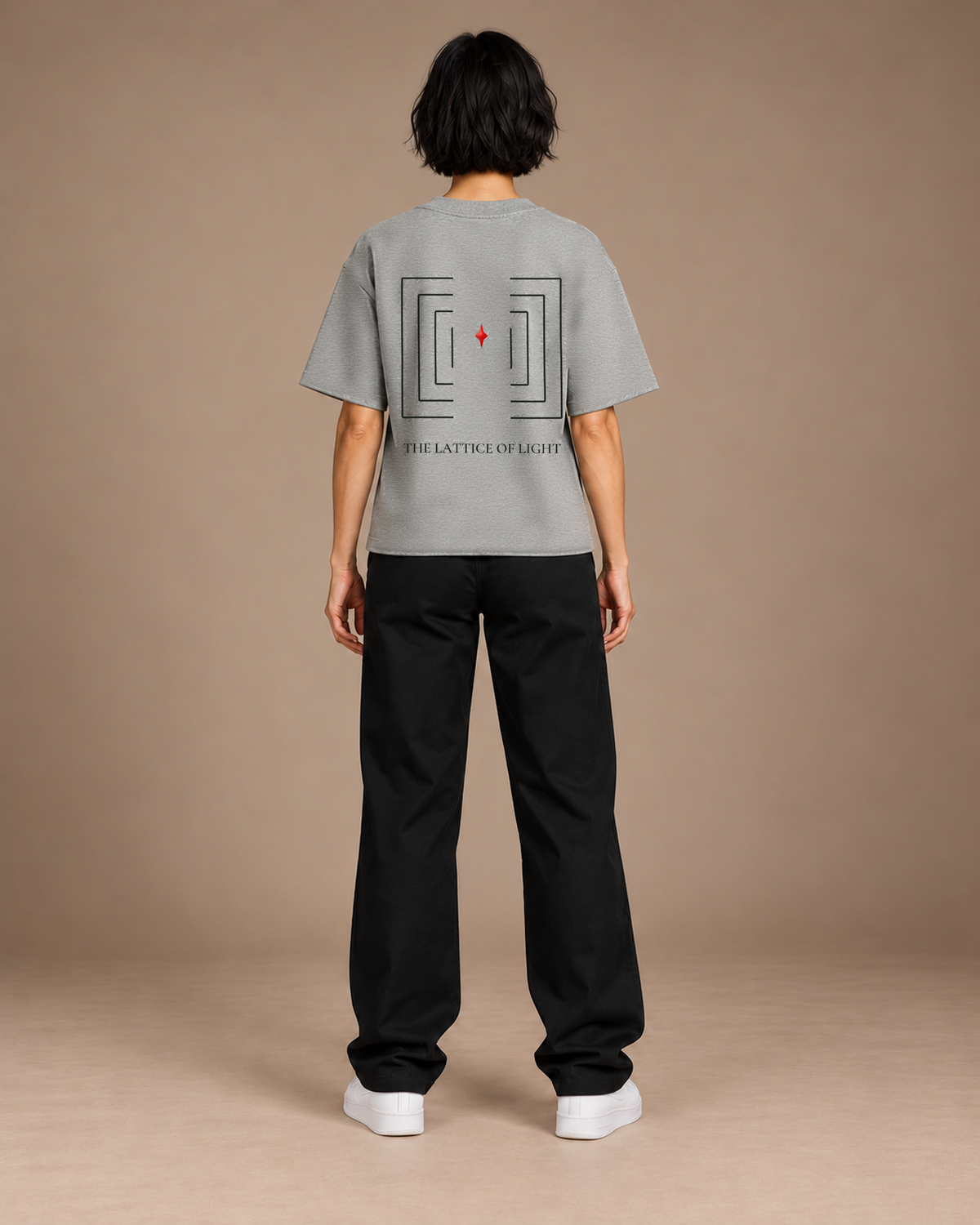 TLOL Lightwell oversized tee in Flower Gray, back view on a model showing the geometric artwork.