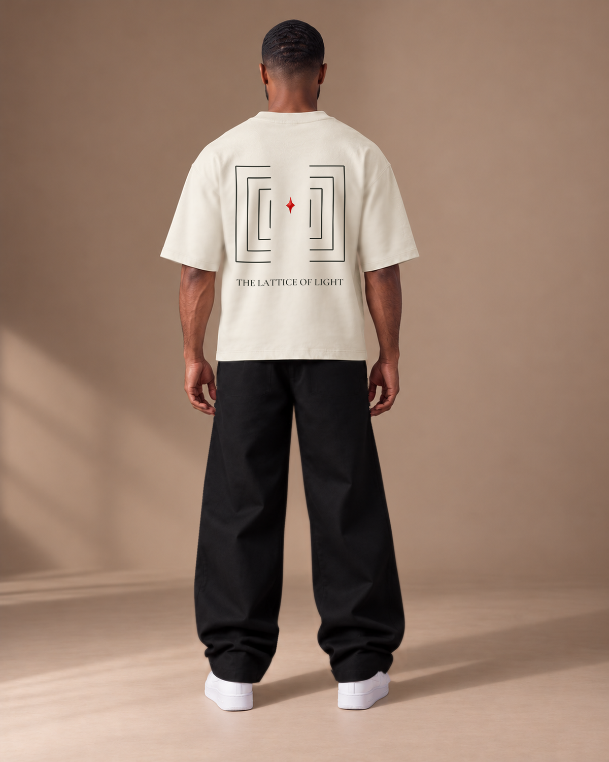TLOL Lightwell oversized tee in Gray, back view on a model showing the geometric artwork.