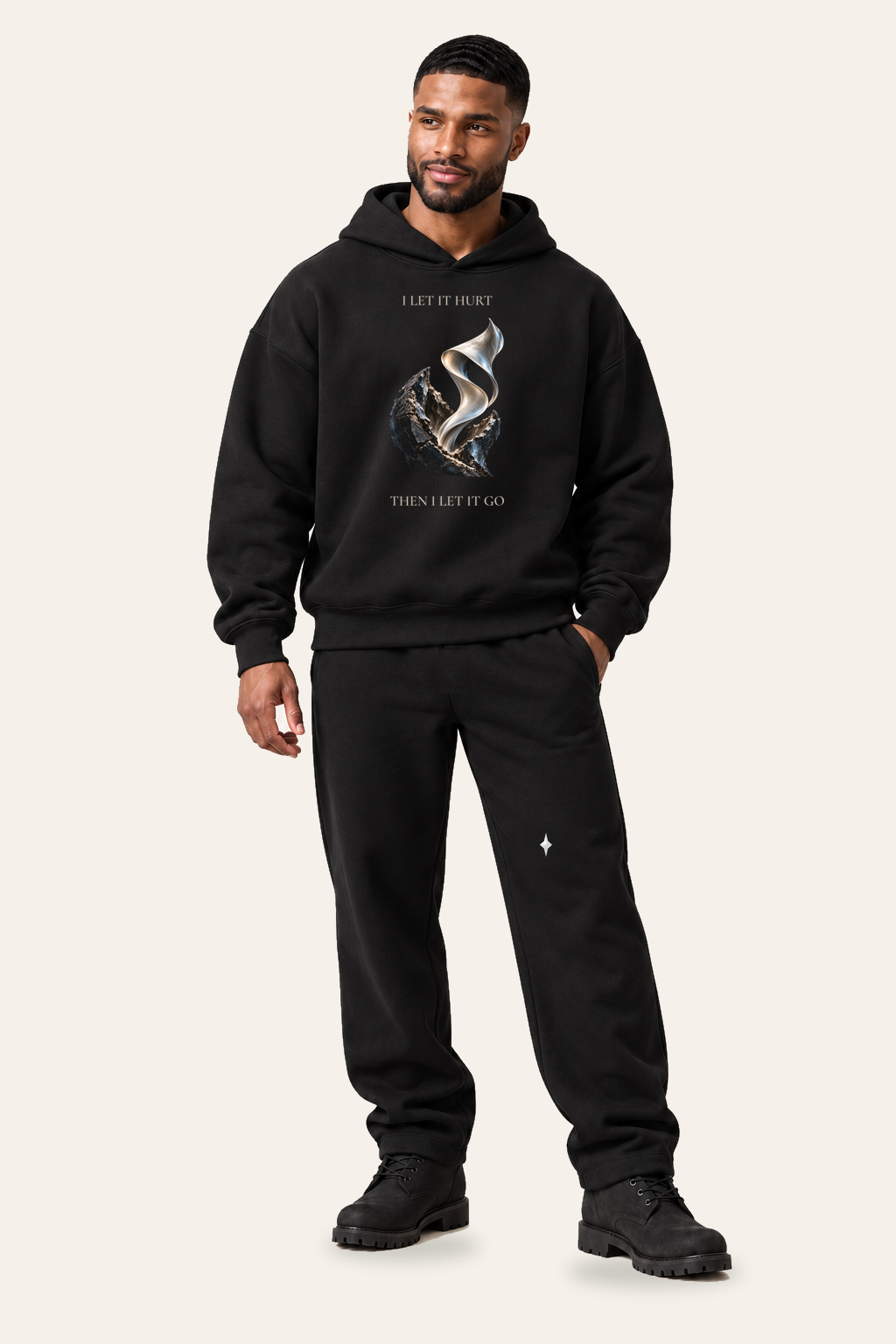TLOL RELEASE Black Beauty pants, standing editorial on light beige. Hoodie and pants sold separately.