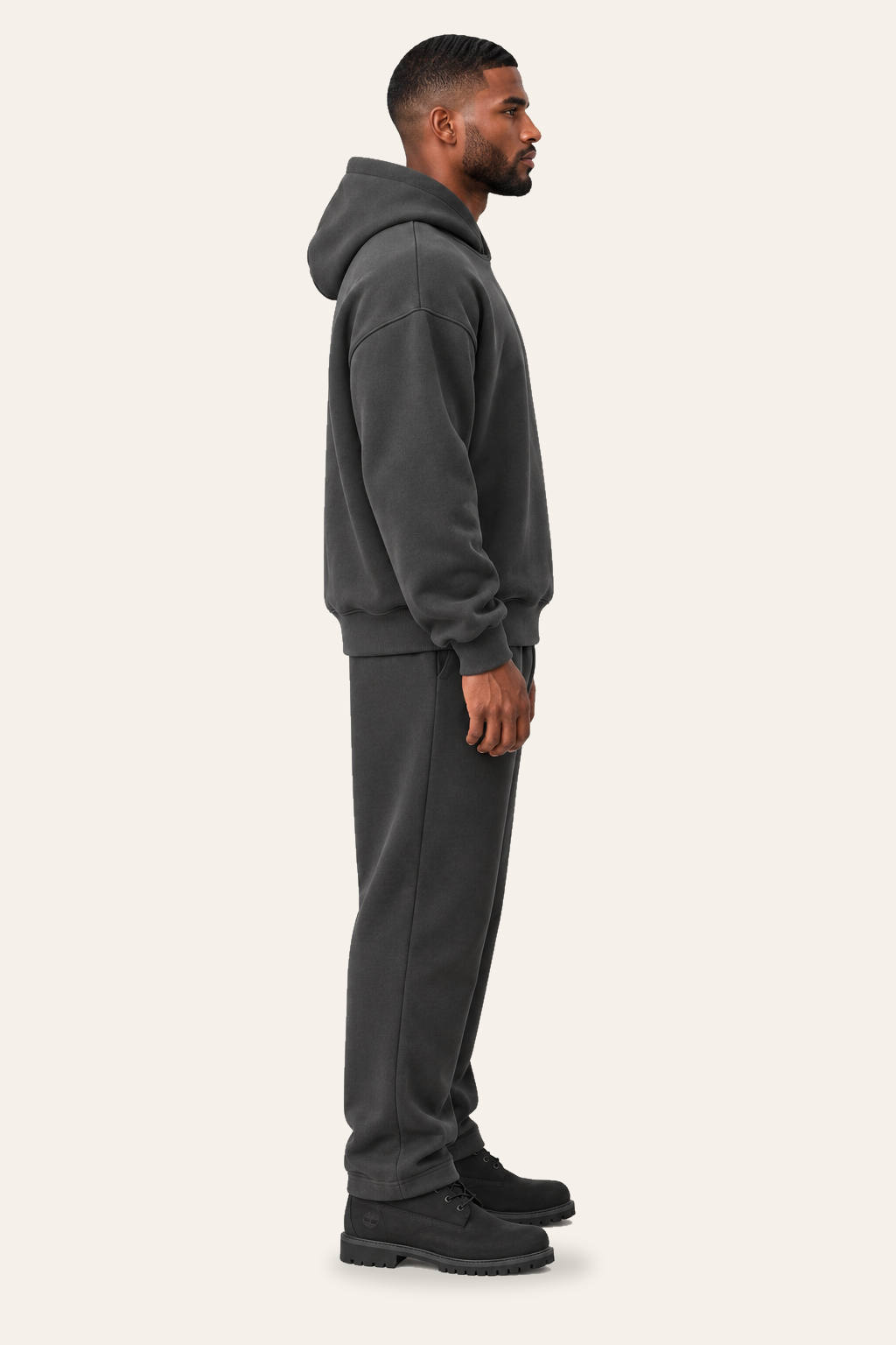 TLOL RELEASE Charcoal hoodie, true right profile on light beige. Hoodie and pants sold separately.