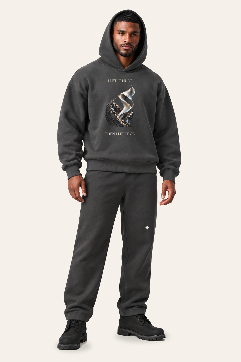 TLOL RELEASE Charcoal pants, standing editorial on light beige. Hoodie and pants sold separately.