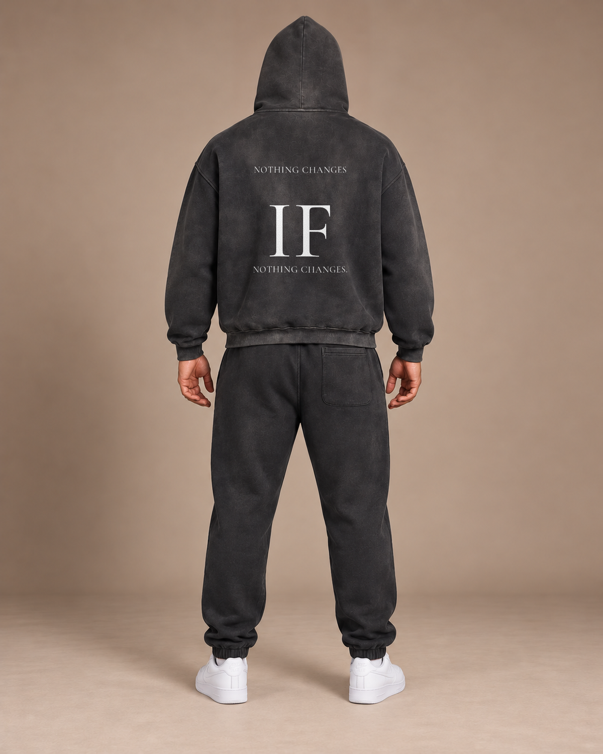 Male model wearing the black TLOL Threshold set, back view showing NOTHING CHANGES / IF / NOTHING CHANGES on the hoodie