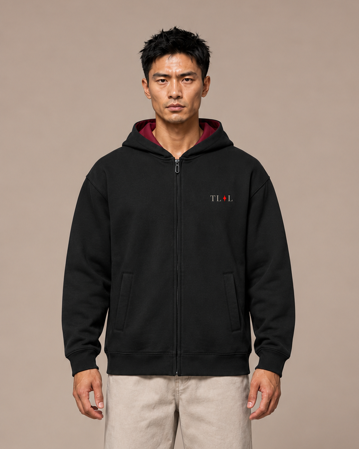 Model wearing the Black TLOL Me Against Me Full-Zip Hoodie, front view.